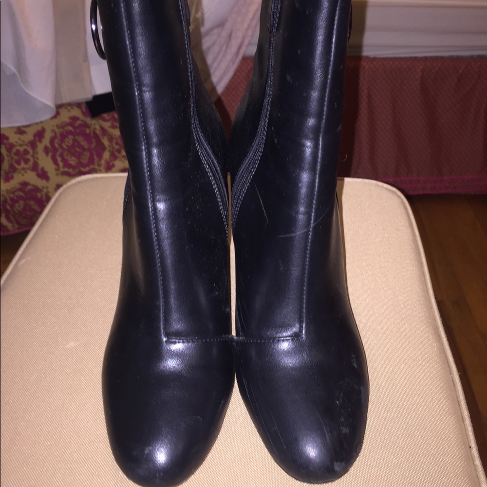 Black ankle booties with circle zipper